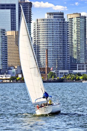 Sailboat sailing in Toronto harbour with downtown view