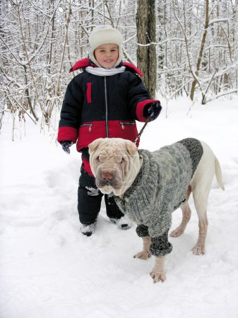 Boy with dog in winter park