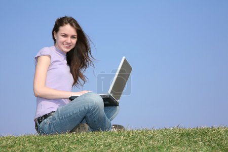 Girl with notebook on meadow 2
