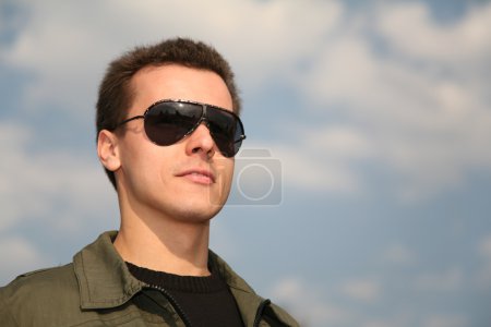 Man with glasses on sky