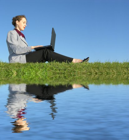 Businesswoman sit with notebook on blue sky