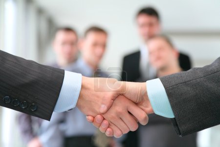 Shaking hands with wrists and business team
