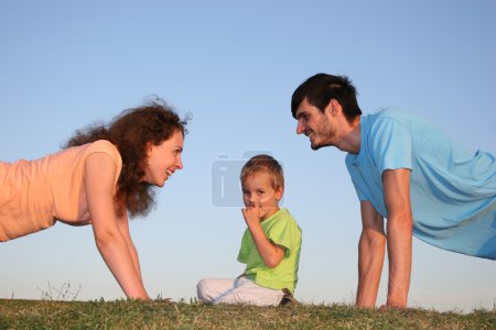 Kid and parents on grass