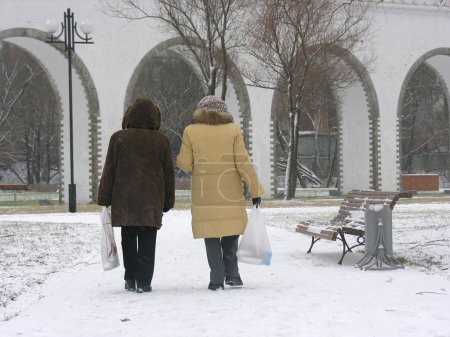Two woman's back. winter