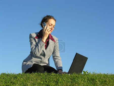 Businesswoman with notebook and phone