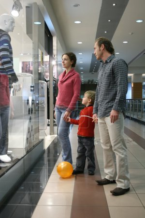 Family and shop window