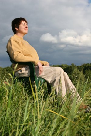 Woman resting on meadow