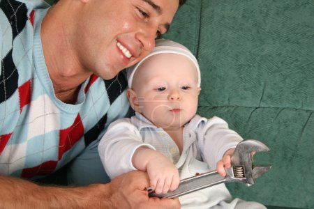 Father with baby with extension wrench