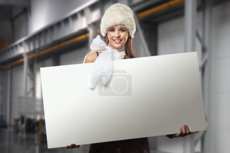 Smiling girl holding white blank