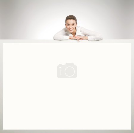 Beautiful businesswoman showing empty white board
