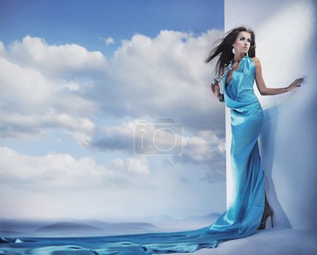 Stunning female beauty wearing blue dress