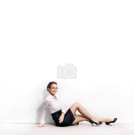 Businesswoman under an empty white board , lots of copyspace