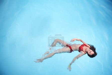 Beautiful young woman at a swimming pool