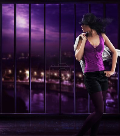 Dancing girl wearing a hat over abstract background