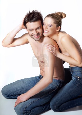 Happy young couple in casual clothing, white background