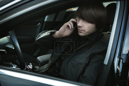 Elegant man in a car, calling