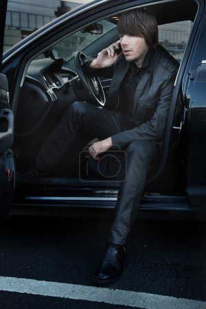 Elegant man in a car, calling