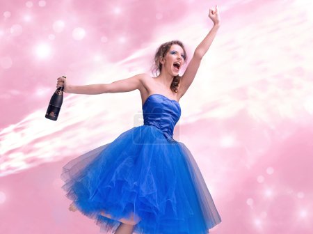 Photo of young brunette holding up a bottle of champagne