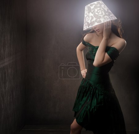 Design style photo of a young beauty with glowing lamp