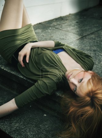 Portrait of young woman lying on ground