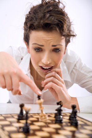Young chess player losing a game