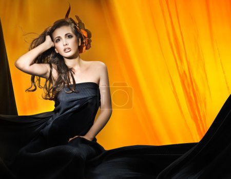 Young attractive woman over yellow background