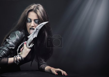 Rock-star woman holding a knife