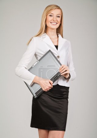 Beautiful blonde businesswoman holding laptop