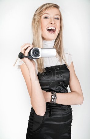 Beautiful blonde holding a videocamera