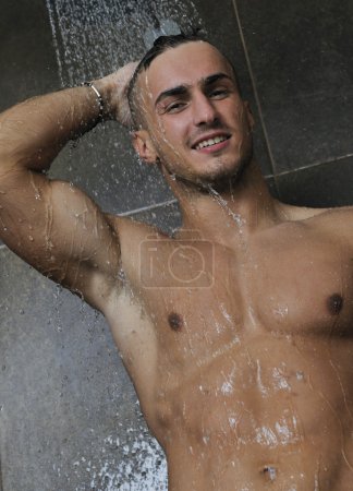 Good looking man under man shower
