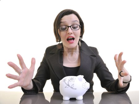 Woman putting coins in piggy bank