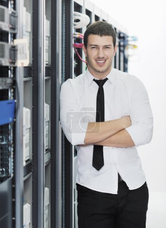 Young handsome business man it engeneer in datacenter server room
