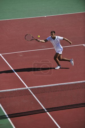Young man play tennis outdoor