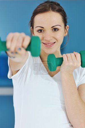 Happy diet concept with young woman on pink scale at sport fitnes gym club