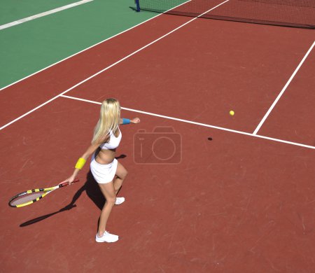 Young woman play tennis game outdoor