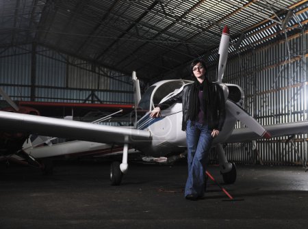 Young woman with private airplane