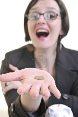 Woman putting coins in piggy bank