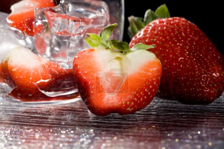photo of delicious red strawberries on ice cubes