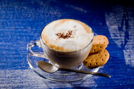 Cappuccino on blue glass table