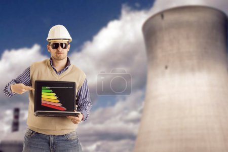 Engineer is presenting the vantages of nuclear energy with a graph on his notebook