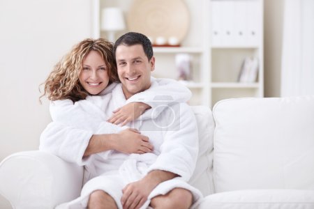 Young married couple in dressing gowns at home