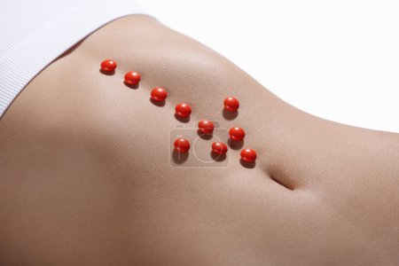The red arrow on the abdomen of a young girl