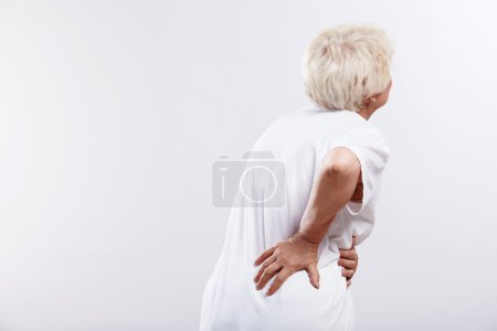 An elderly woman with back ache