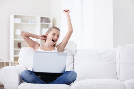Yawning girl with laptop
