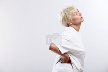 An elderly woman clinging to the waist on a white background