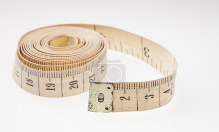 Measuring tape on light background, a symbol of struggle against excess weight