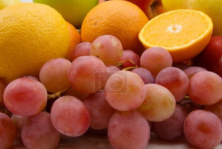 Fresh fruits and grapes background