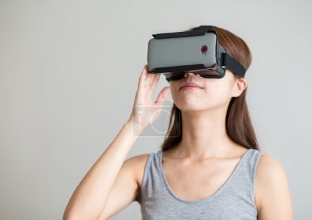 Woman holding virtual reality device