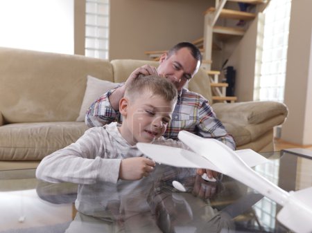Father and son assembling airplane toy
