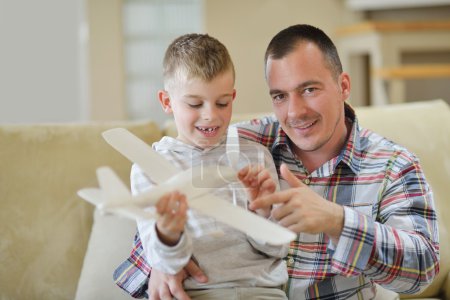 Father and son assembling airplane toy